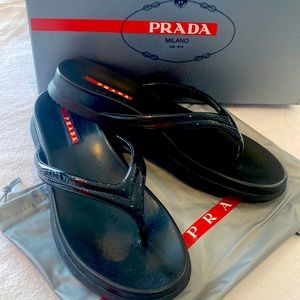 Prada Sz-7 black patent leather sports flip flops. Comes box and dust pouch.